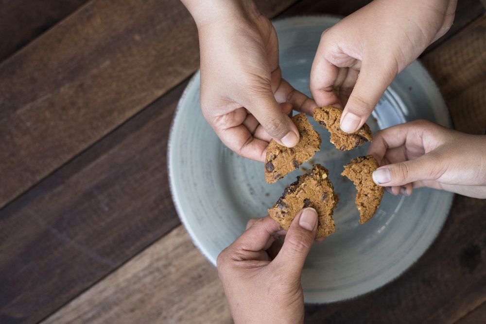 Four Hands Sharing a Cookie