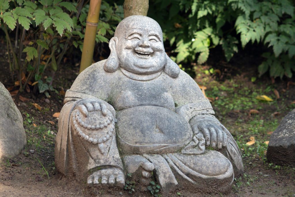 Happy Buddha statue in garden