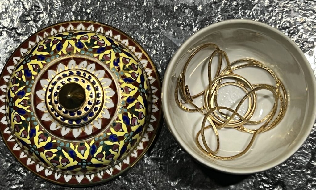 Bowl from Asia with chain and ring inside.