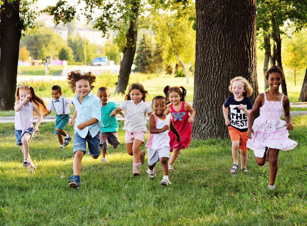 Children running happily through the grass
