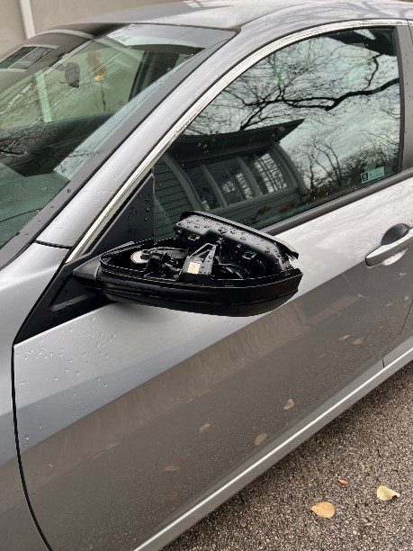 Daily chaos:  car with smashed side mirror
