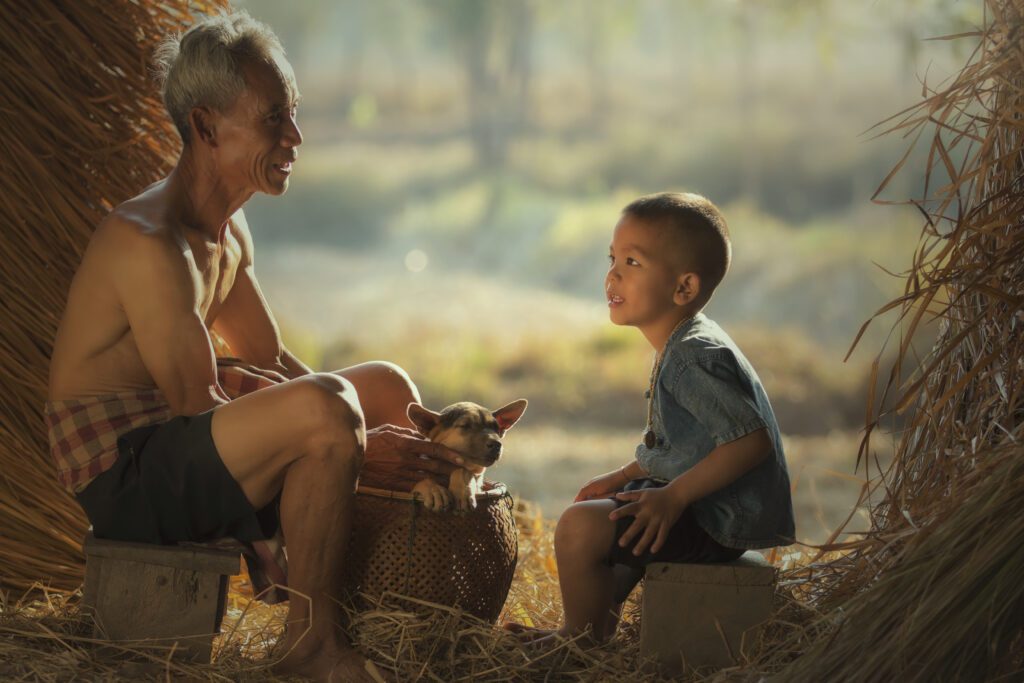 Asian Island man telling story to small boy