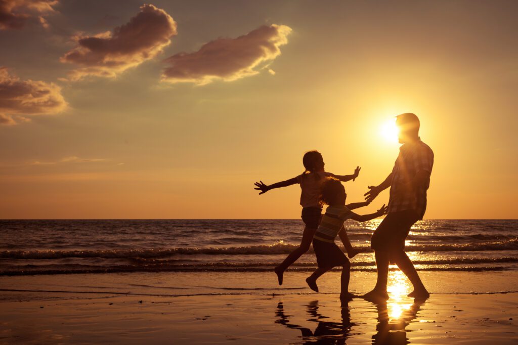 Visualizing happy moments, such as this family on the beach, is the beginning of creating more happiness in our lives
 